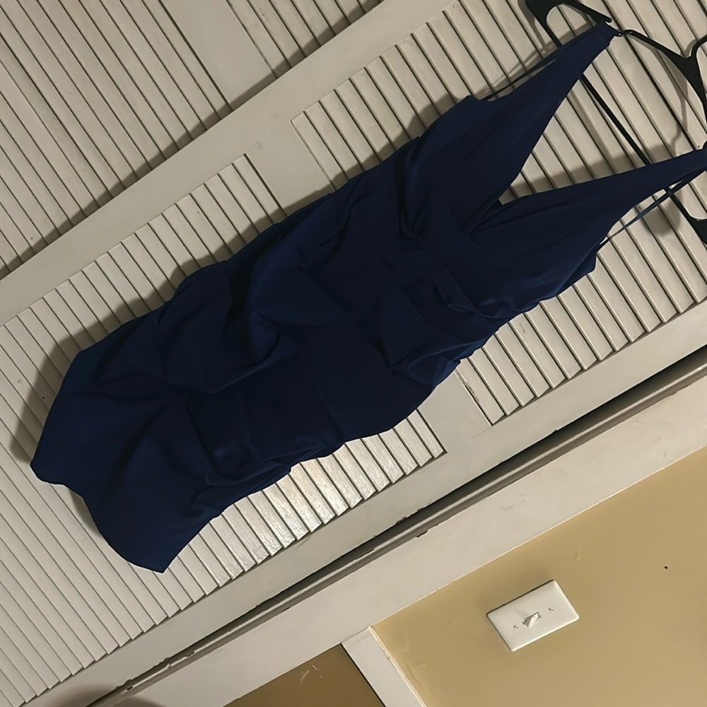 Brand new blue cocktail dress. Stretchy material but has a zipper down the back.
